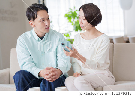 Couples looking at smartphones Couples looking at smartphones 131379313