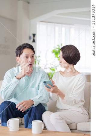 Couples looking at smartphones Couples looking at smartphones 131379314
