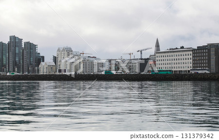 Reykjavik, Iceland. A calm harbor scene with a modern city skyline Reykjavik, Iceland. A calm harbor scene with a modern city skyline 131379342