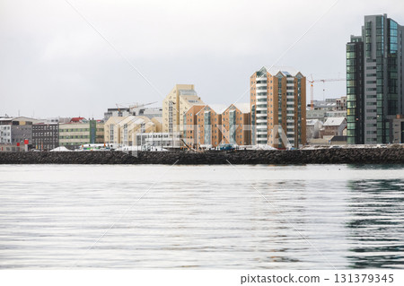 Reykjavik, Iceland, a tranquil harbor scene along a rocky breakwater Reykjavik, Iceland, a tranquil harbor scene along a rocky breakwater 131379345