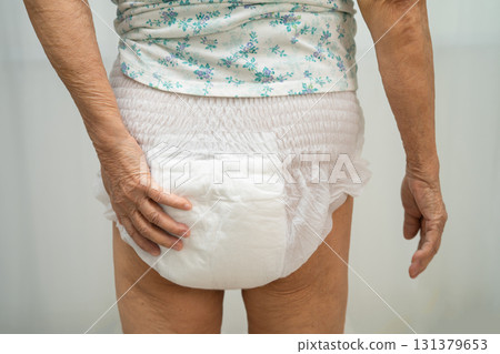 Asian senior woman patient wearing adult incontinence diaper pad in hospital. Asian senior woman patient wearing adult incontinence diaper pad in hospital. 131379653