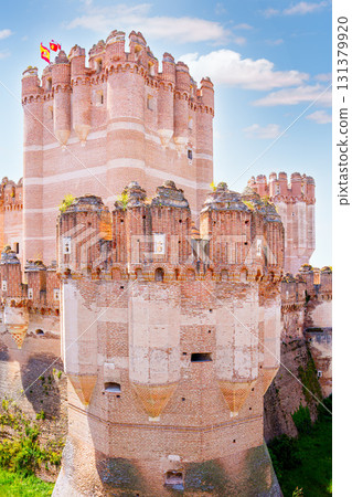 Coca castle showing spanish flag waving in the wind on sunny day Coca castle showing spanish flag waving in the wind on sunny day 131379920