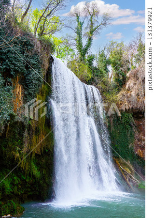 Waterfall cascading into turquoise pond at monasterio de piedra natural park 131379921