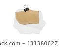 Torn piece of school notebook in a grid and brown piece of paper with beige tape and black binder isolated on white background 131380627