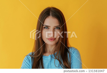 Confident look, portrait. Young woman is against yellow background 131381047