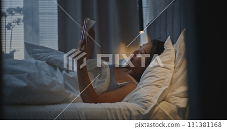 Girl Relaxes in Modern Cozy Bedroom After Hard Day Girl Relaxes in Modern Cozy Bedroom After Hard Day 131381168