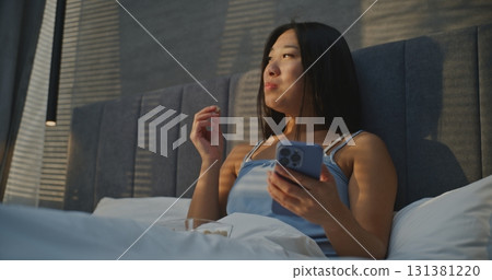 Beautiful Woman Eats Nuts For Breakfast In Bed, and Chats With Friends Online Beautiful Woman Eats Nuts For Breakfast In Bed, and Chats With Friends Online 131381220