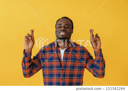 Cafe worker. Black man is in the studio against yellow background 131381264