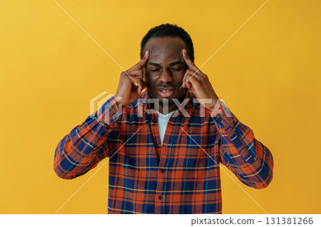 Cafe worker. Black man is in the studio against yellow background Cafe worker. Black man is in the studio against yellow background 131381266