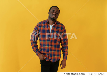 Cafe worker. Black man is in the studio against yellow background Cafe worker. Black man is in the studio against yellow background 131381268