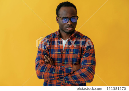 Cafe worker. Black man is in the studio against yellow background Cafe worker. Black man is in the studio against yellow background 131381270