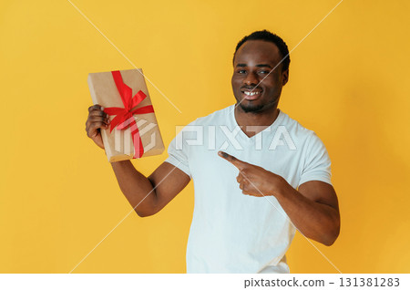 Cafe worker. Black man is in the studio against yellow background 131381283
