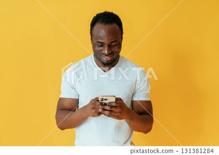 Cafe worker. Black man is in the studio against yellow background 131381284