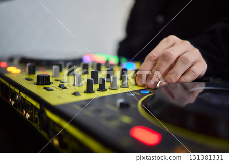 Witness the DJ mixing equipment performing live and in action at a vibrant music event 131381331