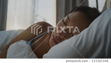 Beautiful Woman Sleeps on Soft Pillow in Cozy White Bed 131381346