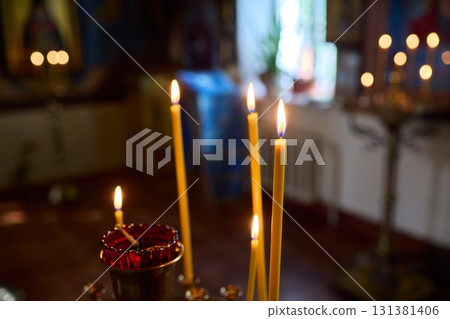 An Elegant Candle Holder featuring Lit Candles within a Beautiful and Serene Setting An Elegant Candle Holder featuring Lit Candles within a Beautiful and Serene Setting 131381406