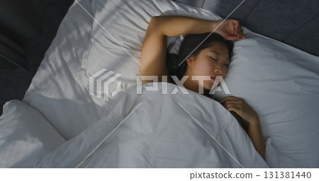 Young Girl Falls into Bed With Arms Outstretched, Smiling, Enjoying Moment 131381440