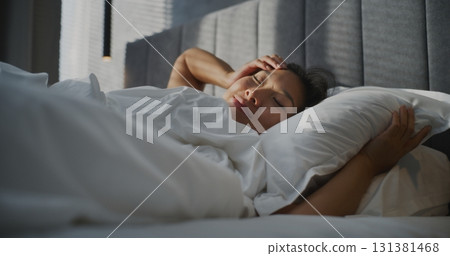 Young Woman Wakes Up Early in Morning In Bedroom Young Woman Wakes Up Early in Morning In Bedroom 131381468