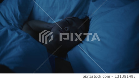 Young Woman Lies Awake at Night, Unable to Sleep Young Woman Lies Awake at Night, Unable to Sleep 131381495