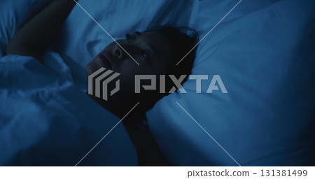 Young Woman Lies Awake at Night, Unable to Sleep Young Woman Lies Awake at Night, Unable to Sleep 131381499