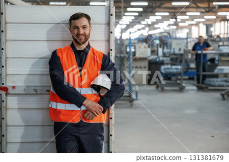 Factory worker is indoors with hard hat Factory worker is indoors with hard hat 131381679