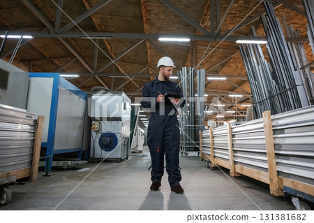 Factory worker is indoors with hard hat 131381682