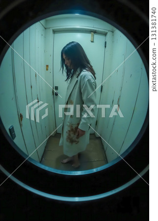 Stalker of young woman seen through peephole 131381740