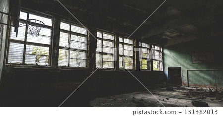 Gym at school.Old basketball hoop. Old windows.Horror concept. window silhouette. Scary bars on the windows. Panorama. Gym at school.Old basketball hoop. Old windows.Horror concept. window silhouette. Scary bars on the windows. Panorama. 131382013