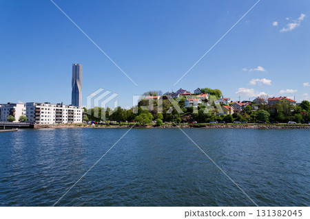 Picturesque colony of old small wooden historic houses on the Slottsberget mountain on the banks of the Gota alv river, Gothenburg, Sweden, sunny day 131382045