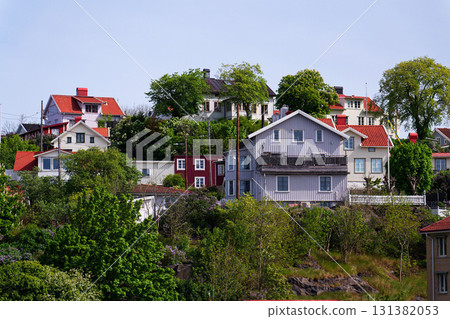Picturesque colony of old small wooden historic houses on the Slottsberget mountain on the banks of the Gota alv river, Gothenburg, Sweden, sunny day Picturesque colony of old small wooden historic houses on the Slottsberget mountain on the banks of the Gota alv river, Gothenburg, Sweden, sunny day 131382053
