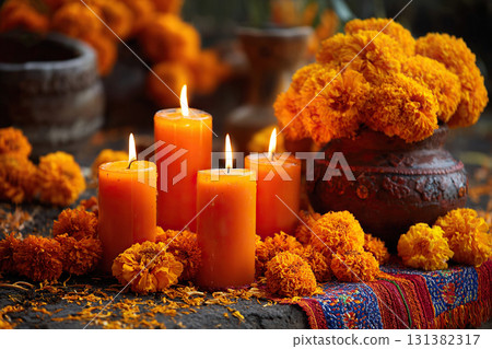 Four lit candles next to a bouquet of marigolds in a vase stand on a towel on a table. Mexican traditions. Day of the Dead. Four lit candles next to a bouquet of marigolds in a vase stand on a towel on a table. Mexican traditions. Day of the Dead. 131382317