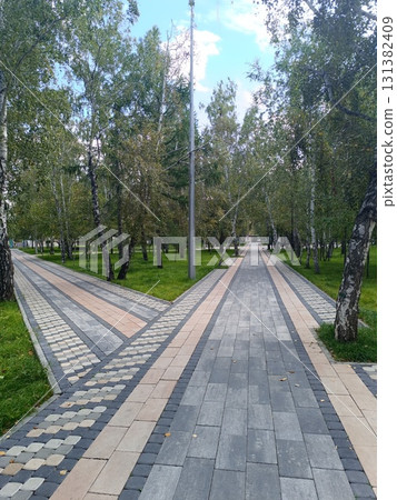 A park with colorful paving stones and trees. A park with colorful paving stones and trees. 131382409