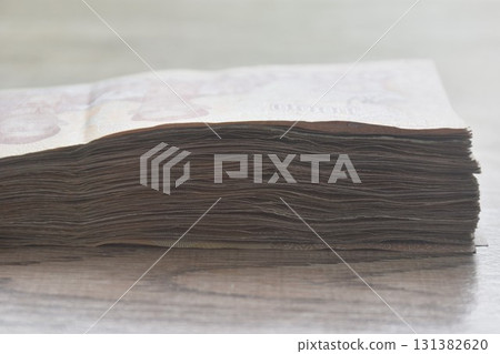 Thai thousand banknote arranging on woodentable background and texture 131382620