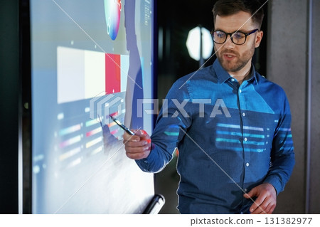 Business coach against projector with data 131382977