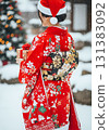 A woman wearing a Christmas-patterned kimono 131383092