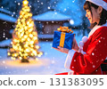 A woman wearing a Christmas-patterned kimono and a Christmas tree 131383095