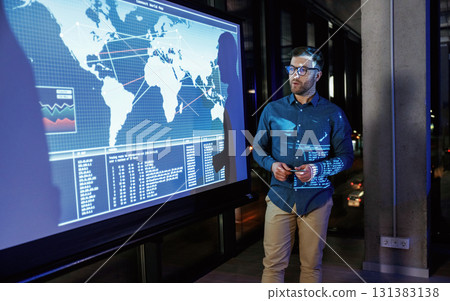 Conception of start up. Business coach against projector with data Conception of start up. Business coach against projector with data 131383138