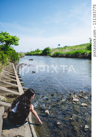 Woman relaxing by the river 131383778