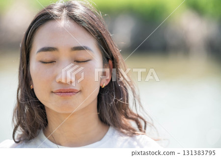 Woman relaxing by the river Woman relaxing by the river 131383795