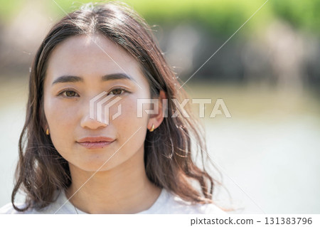 Woman relaxing by the river 131383796