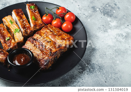 Closeup of pork ribs grilled with BBQ sauce and caramelized in honey. Closeup of pork ribs grilled with BBQ sauce and caramelized in honey. 131384019