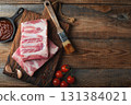 Raw pork ribs with spices, salt and rosemary on dark wooden background 131384021