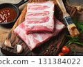 Raw pork ribs with spices, salt and rosemary on dark wooden background 131384022