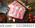 Raw pork ribs with spices, salt and rosemary on dark wooden background 131384023
