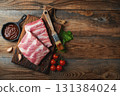Raw pork ribs with spices, salt and rosemary on dark wooden background 131384024