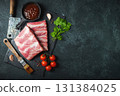 Raw meat. Raw pork ribs from the back with meat on a black background. background image 131384025