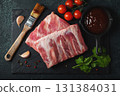 Raw meat. Raw pork ribs from the back with meat on a black background. background image 131384031