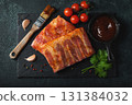 Ready for BBQ raw pork spare ribs with barbecue sauce. Black background. Top view 131384032