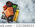 Ready for BBQ raw pork spare ribs with barbecue sauce. Black background. Top view 131384033