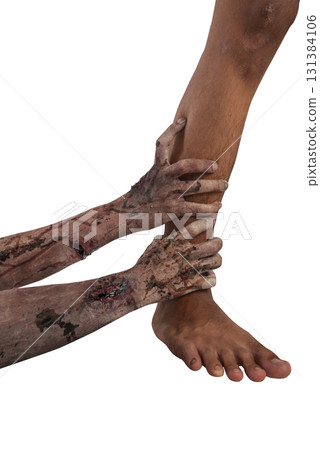 The zombies hand with wounds and blood catches a human foot isolated over a white background. Zombie, devil, evil, satan, or monster hand. Concept of Halloween or Horror The zombies hand with wounds and blood catches a human foot isolated over a white background. Zombie, devil, evil, satan, or monster hand. Concept of Halloween or Horror 131384106